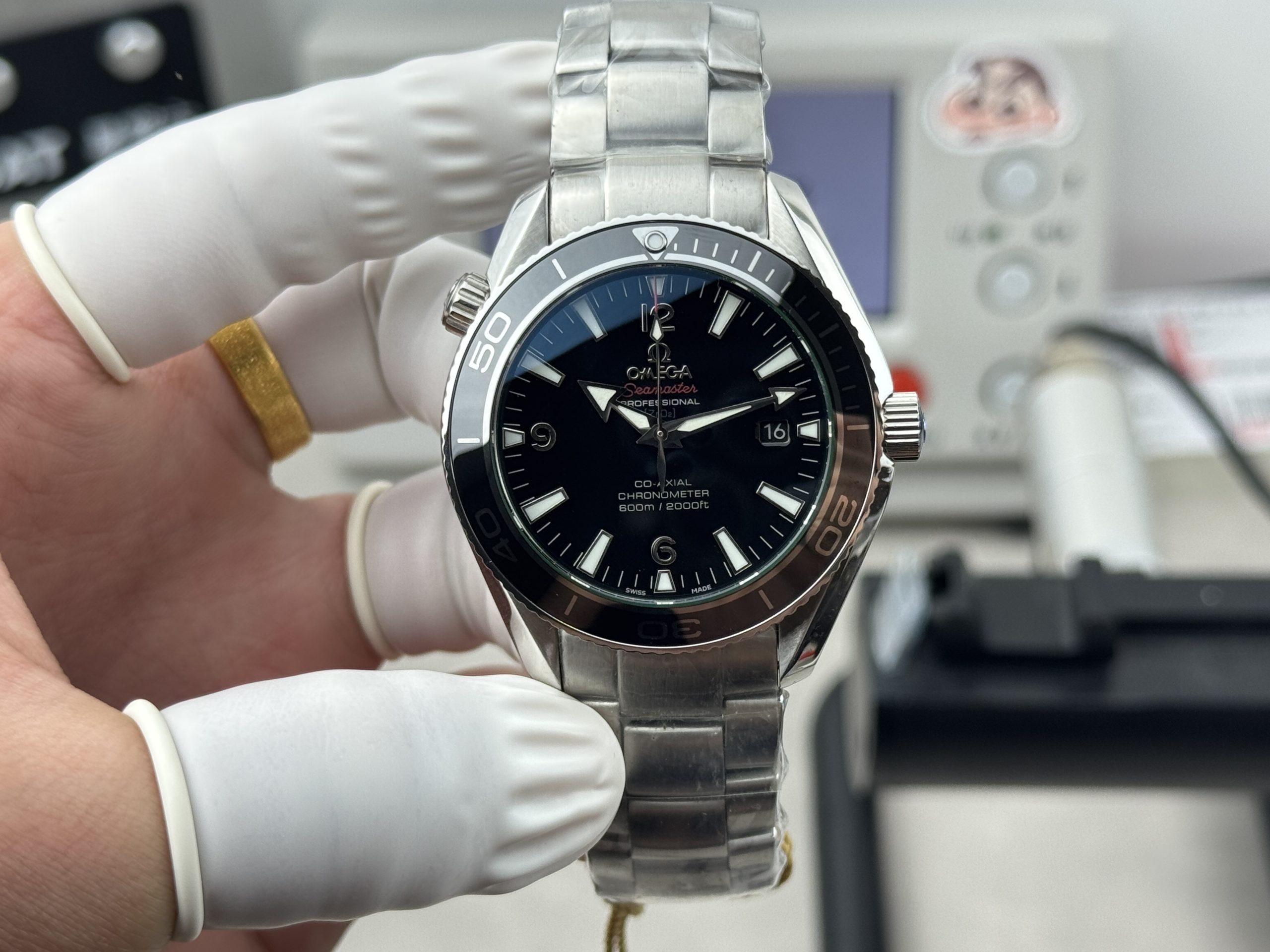 Orange minute markings around the chapter ring of the clone Omega Planet Ocean 600M