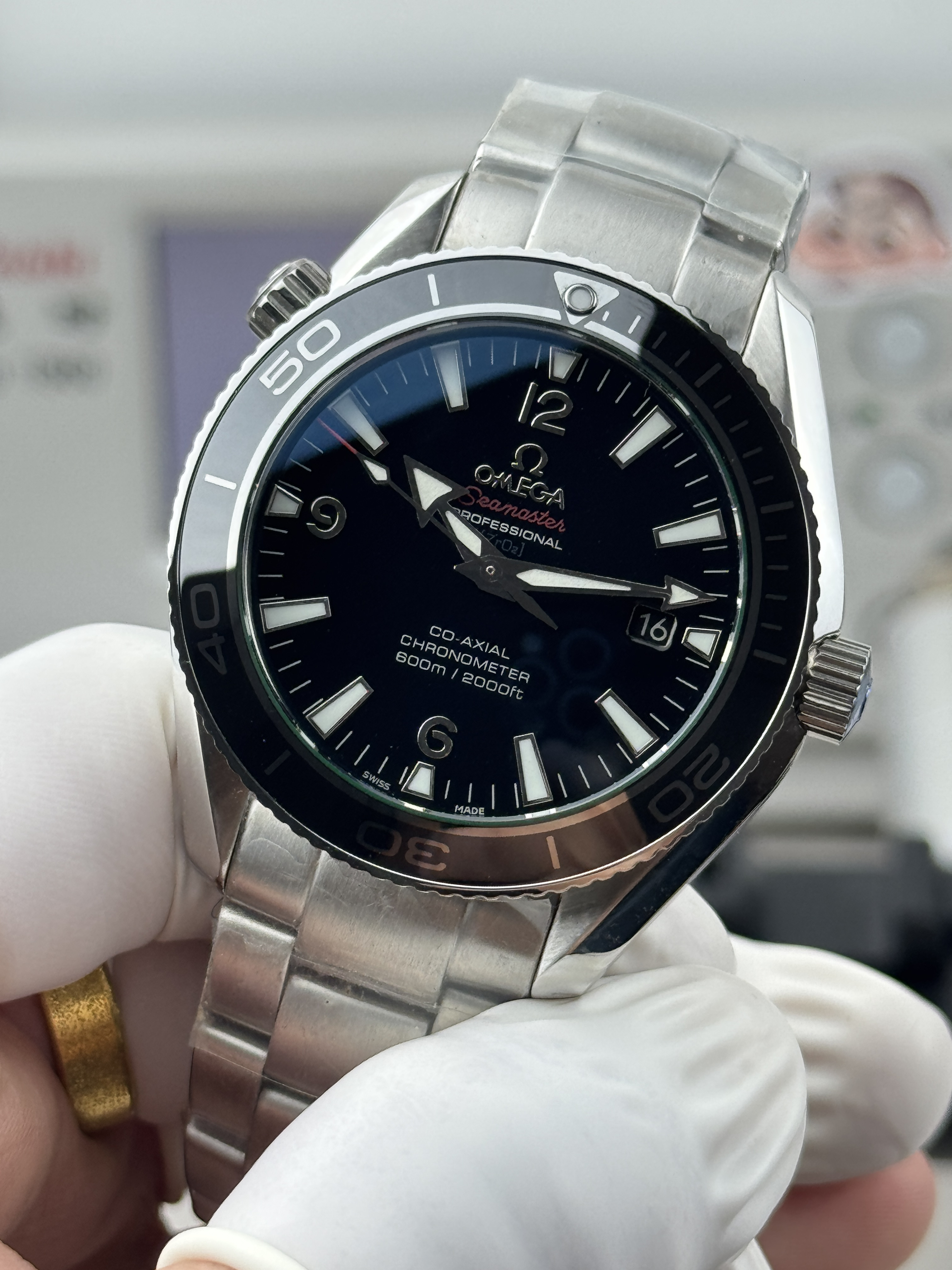 Date window at 3 o'clock cut into the black dial of the clone Omega Planet Ocean 600M