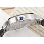 Blue cabochon crown seated between the guards on the polished case side