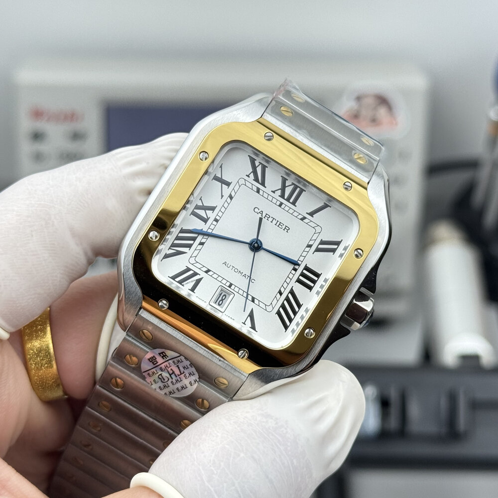 The silver dial sits inside a warm yellow gold bezel, held in white gloves