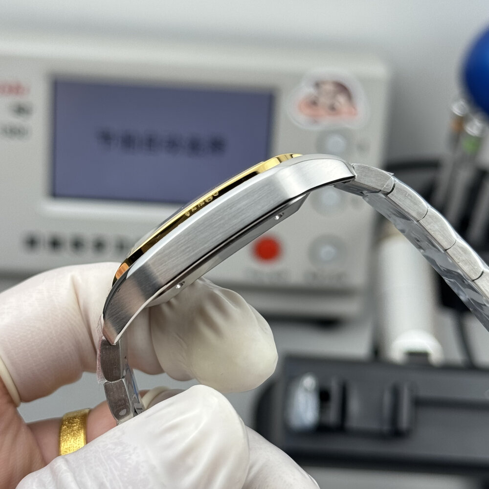 Bezel edge and bracelet curve seen end-on against the workshop bench