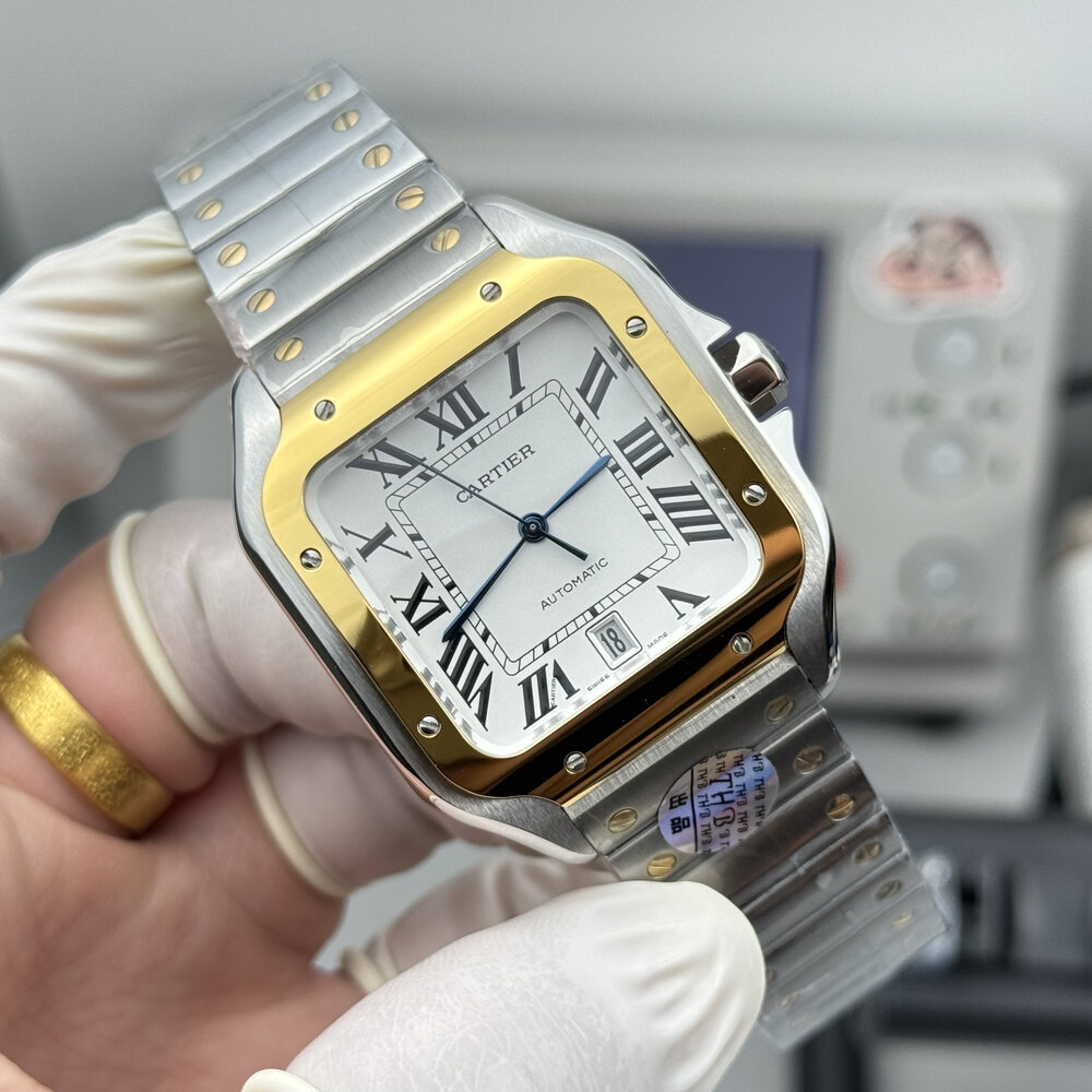 Two-tone Santos angled in gloved fingers, date aperture open at six o'clock