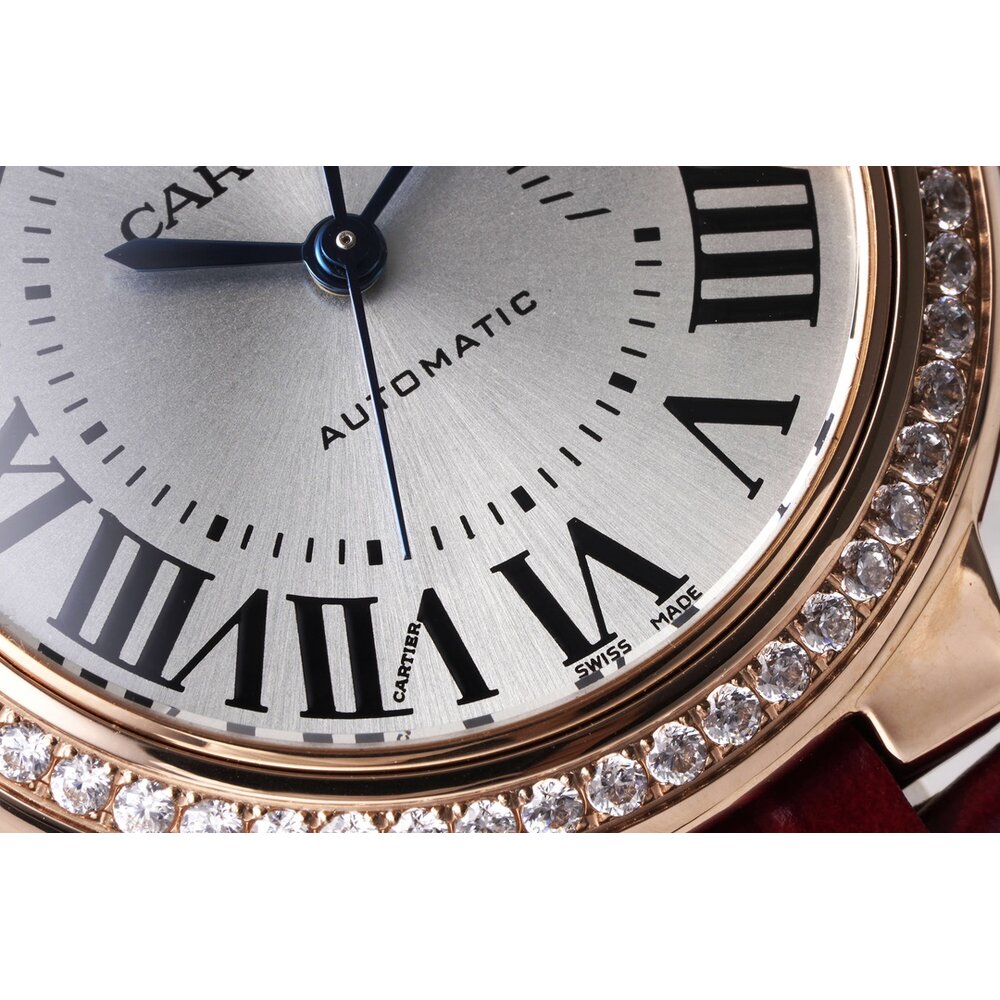 Mounted on the case side, the gold-tone fluted crown holds its blue cabochon