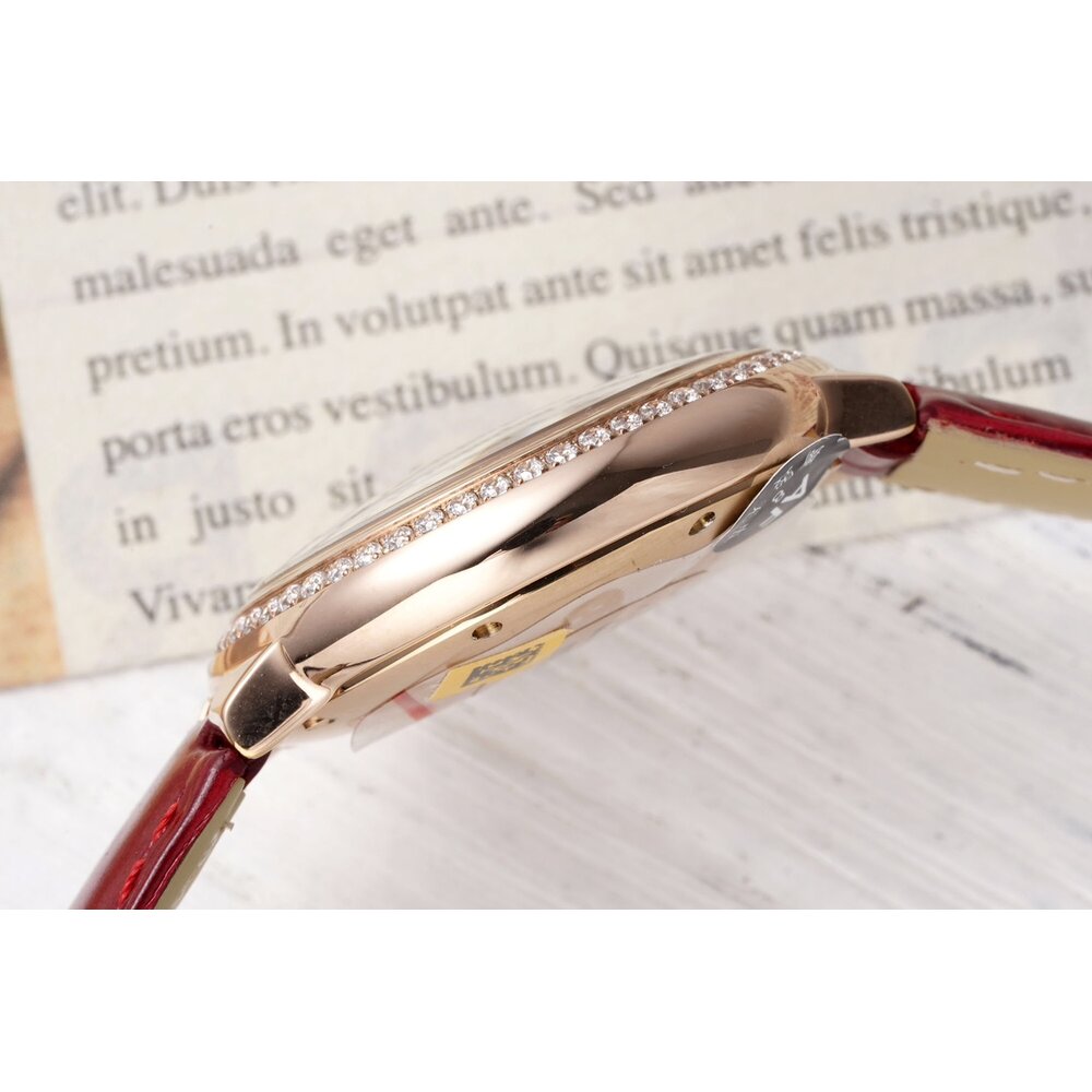 Cardinal hours of the 33mm dial carry printed Roman numerals