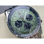 Luminous steel baton hands and stick markers over the mint green sunburst of the Navitimer