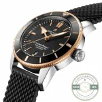 Red gold-coloured coin-edge bezel around a black ring with gold-filled markers
