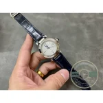 In the palm at arm's length, the round case sitting small against the fingers