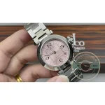 Bracelet wrapped round the fingers, pink dial turned toward the light