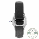 Strap doubled back through its buckle, grained leather creasing at the fold