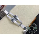 Folding deployment clasp opened flat beside the stone-set bracelet
