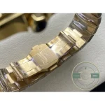 Gold bracelet arched on the cushion, clasp cover and screw heads in line