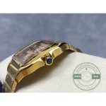 Case flank in gold with the blue cabochon crown seated between its guards