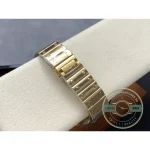 Gold bracelet links laid across the cushion, each centre link screw-pinned