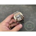Whole watch small in the palm, the openwork dial reading as a lattice of Romans