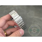 Centre links and screw heads of the skeleton Santos bracelet held in the hand