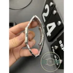 Bracelet looped in the hand, each link squared to match the case shoulders