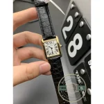 Turned in the fingers, numerals stepping down the long side of the dial