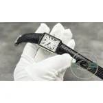Whole watch cupped in the palm, strap hanging loose below the case