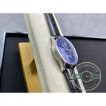 Domed sapphire with anti-reflective coating curves over the blue chronograph dial