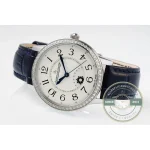 Watch resting at a slant, blue strap arching away from the 34mm steel case