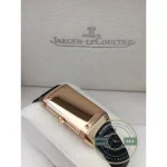 Rose gold tone JLC Reverso replica on the wrist, diamond bezel above a leather strap