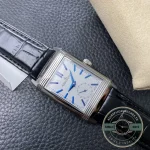 Steel Reverso Tribute Duoface replica caught mid-rotation on its swivelling cradle