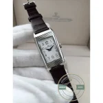 Reverso super clone caught mid-flip, rectangular case swiveling inside its steel cradle