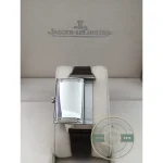 Sapphire crystal over the white Reverso dial, angled shot catching the light on the markers