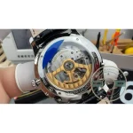 Black alligator strap laid flat next to the steel 1368480 case and its lug line