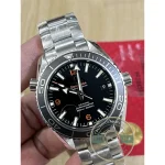 Low off-wrist profile of the super clone Omega Planet Ocean, 42mm steel under a shirt cuff