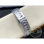 Horizontally embossed sunburst dial with applied batons, steel Cubitus 5821 with emerald green dial