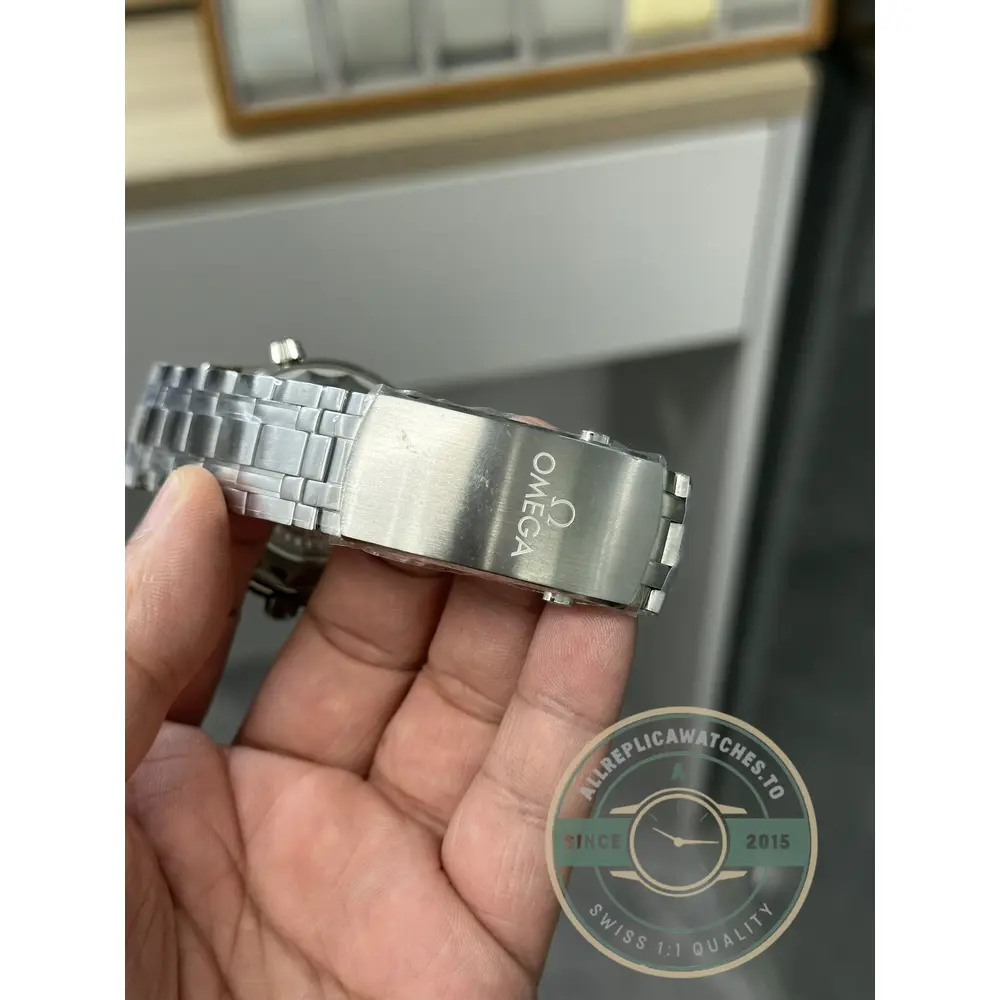 Wave engraving casting shadow lines across the grey dial of this Seamaster clone