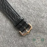 Rose gold pin buckle closed over the alligator strap, tongue through a hole