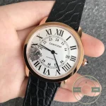 Held in the palm with blued hands sweeping the twenty-four hour ring