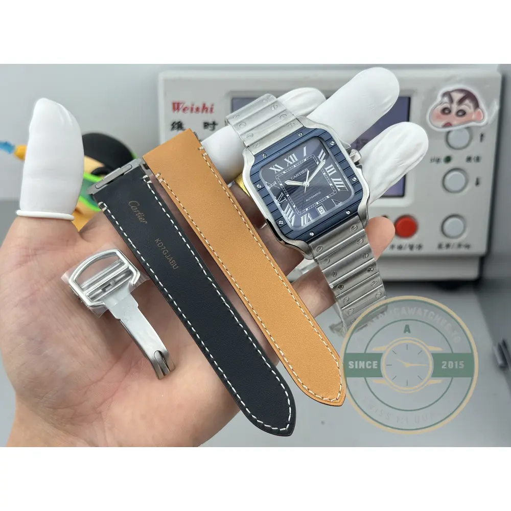Spare black leather strap, buckle and change tool laid out beside the watch