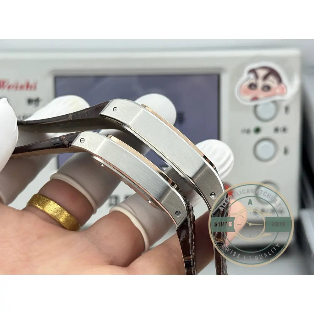 Bare cases of both sizes stacked in the hand, bezels facing the camera