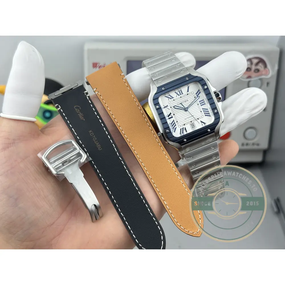 Spare black strap with tan lining, buckle and tool set out beside the watch