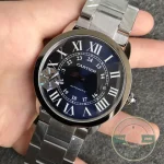 Whole watch held up, blue dial reading dark against the steel bracelet