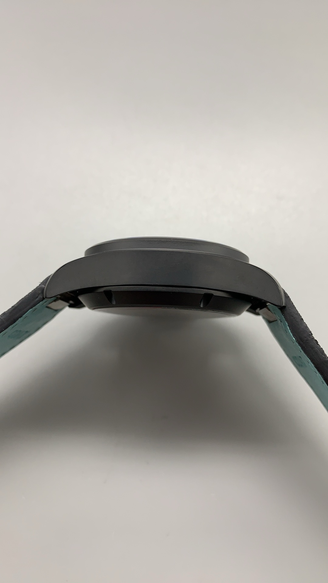Matte titanium hiding fingerprints and micro-abrasions a polished case would show