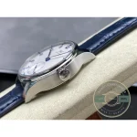 Applied white gold indices lie across a blue lacquered Portugieser dial