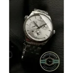 Polished steel hour and minute hands over silver, a blued seconds hand across them