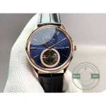 Applied gold baton indices catching the light against the blue dial of this JLC tourbillon clone