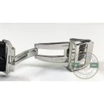 Black alligator-grain leather strap curving away from the brushed steel lug