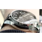 Black alligator leather strap with pale contrast stitching running along the edge