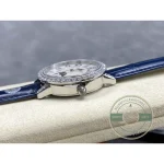 Case lying on a cushion in profile, blue strap running out of the frame