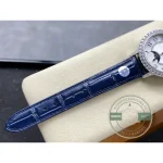 Strap laid flat on the cushion with the diamond-set lug entering the frame