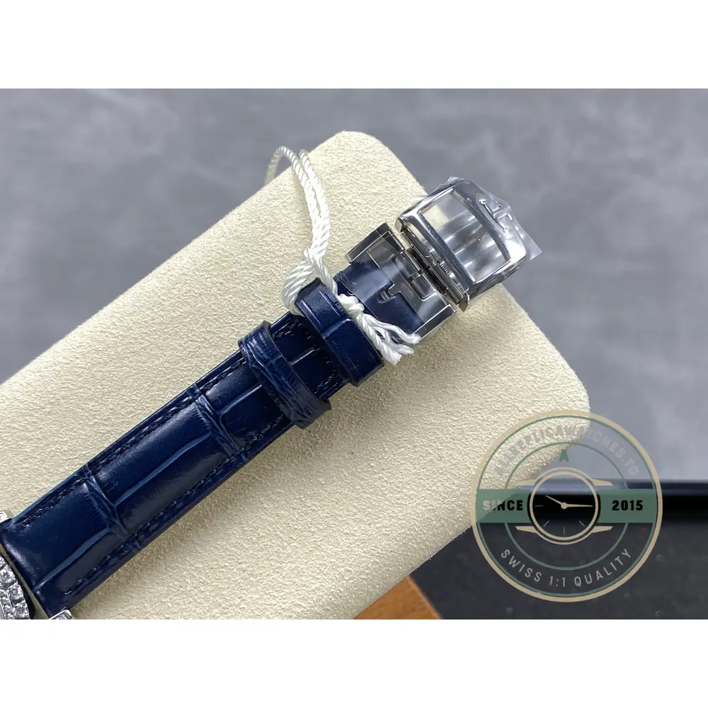 Blue alligator strap hanging with the white gold pin buckle and the paper tag