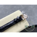 Pink gold pin buckle photographed with its tag still attached to the strap