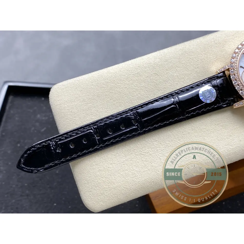 Black alligator strap detail, square scales running toward the pink gold buckle