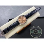 Salmon above, alligator leather below, closed by a folding clasp